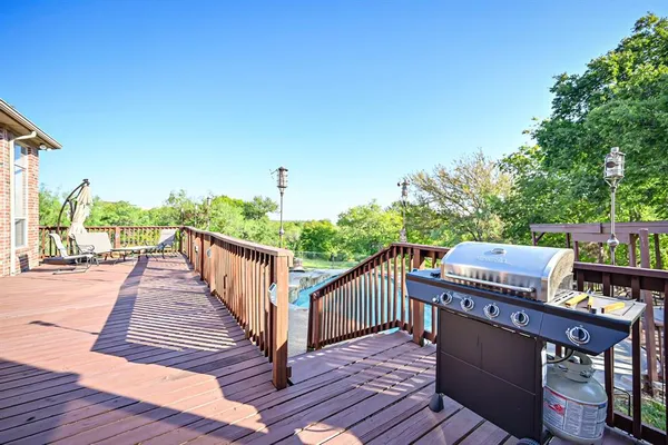 a view of a patio with a table chairs and a backyard