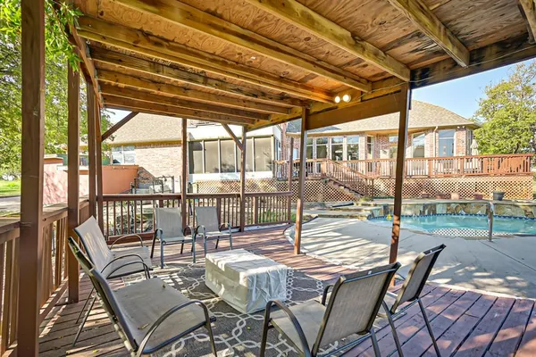 an aerial view of a house with swimming pool and garden