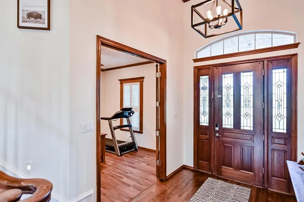 a view of a hallway with wooden floor and stairs