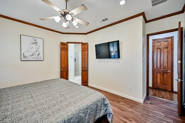 a bedroom with a bed and a flat screen tv