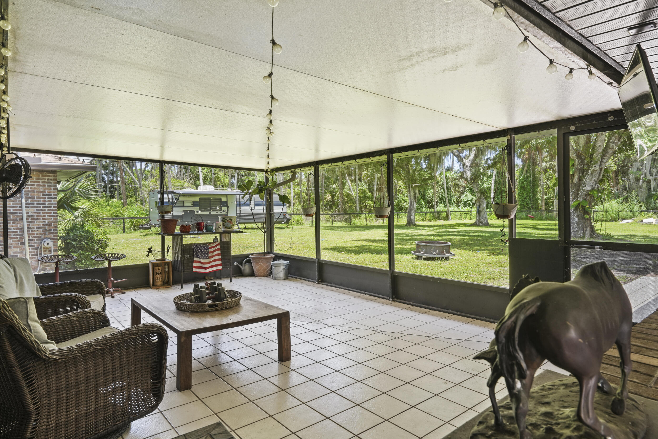 4170 McCarty Road Fort Pierce, FL 34945 - Photo 45 of 57 a living room with furniture and a floor to ceiling window