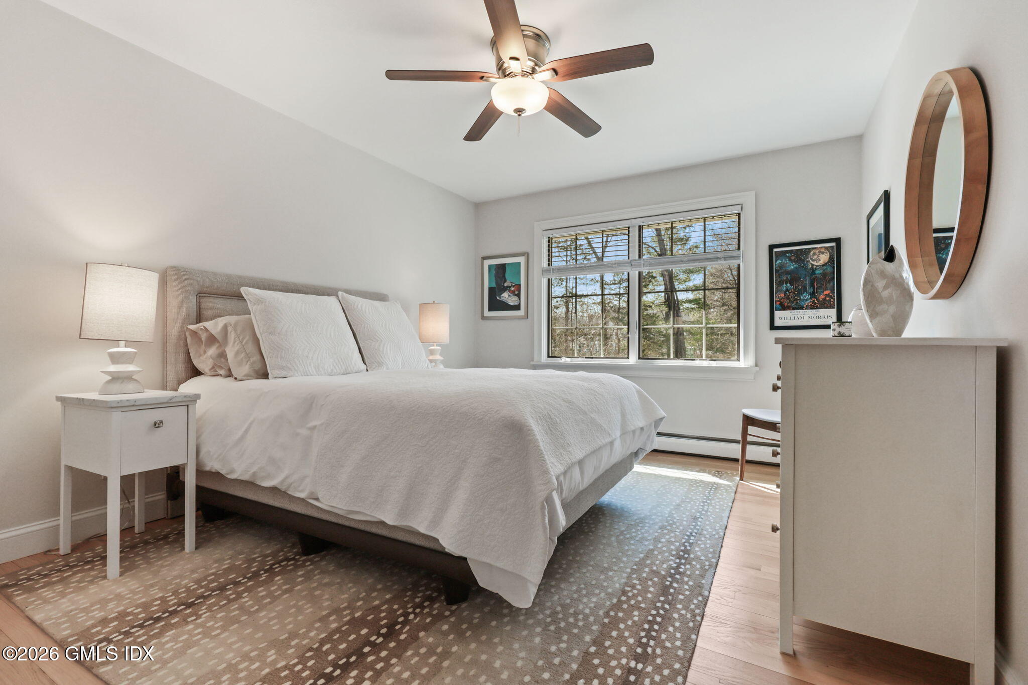 97 Davenport Ridge Lane Stamford, CT 06903 - Photo 20 of 31 a bedroom with a large bed and a chandelier