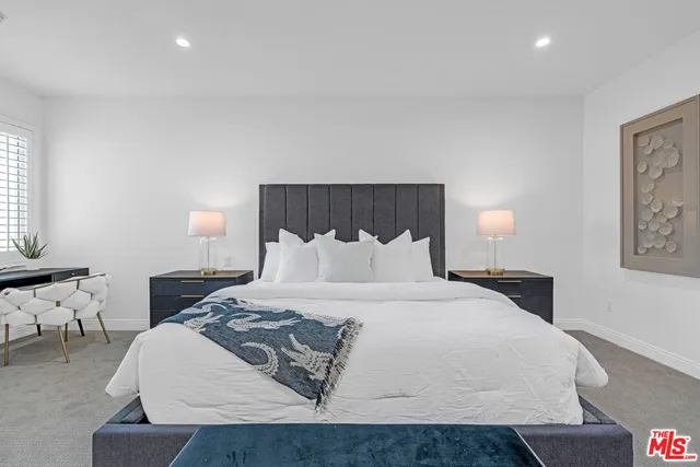 a large white bed in a white room