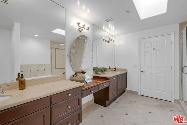 a bathroom with double vanity sinks and a mirror