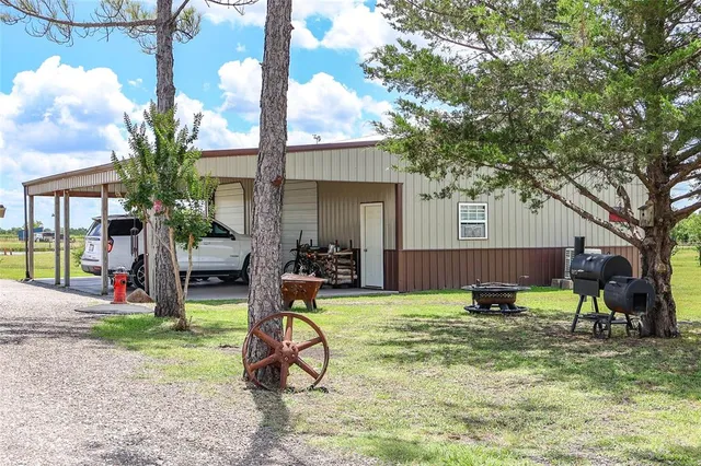 a view of a backyard with table and chairs