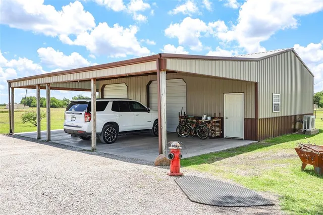 a view of a house with a patio and a yard