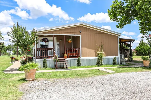 a view of a house with backyard porch and sitting area