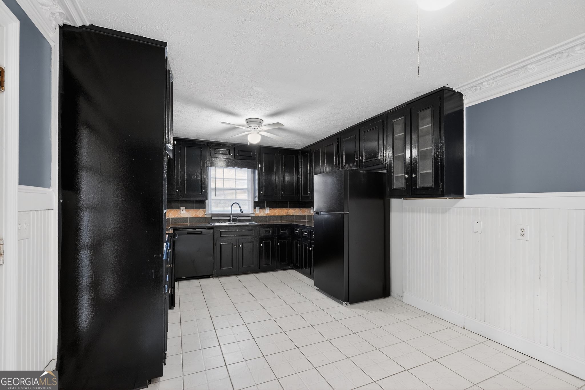 6581 Woodrow Road Lithonia, GA 30038 - Photo 13 of 34 a kitchen with a refrigerator and cabinets