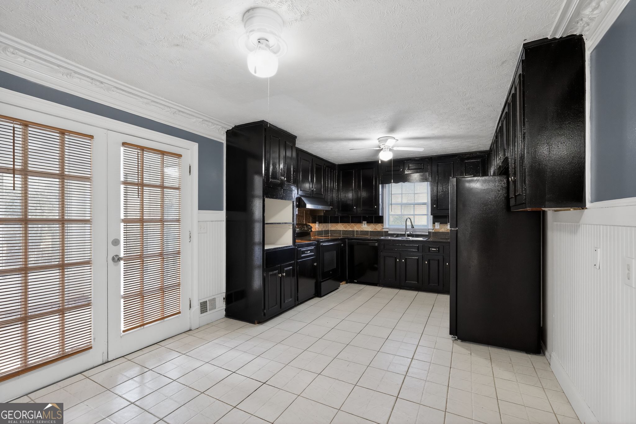 6581 Woodrow Road Lithonia, GA 30038 - Photo 14 of 34 a kitchen with stainless steel appliances kitchen island granite countertop a refrigerator a sink and dishwasher