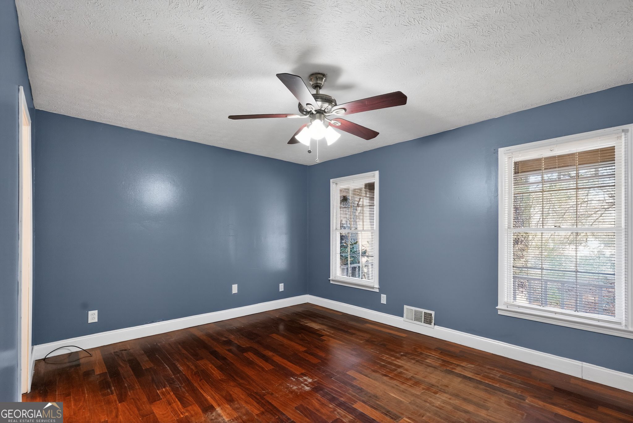 6581 Woodrow Road Lithonia, GA 30038 - Photo 18 of 34 a view of an empty room with window and wooden floor