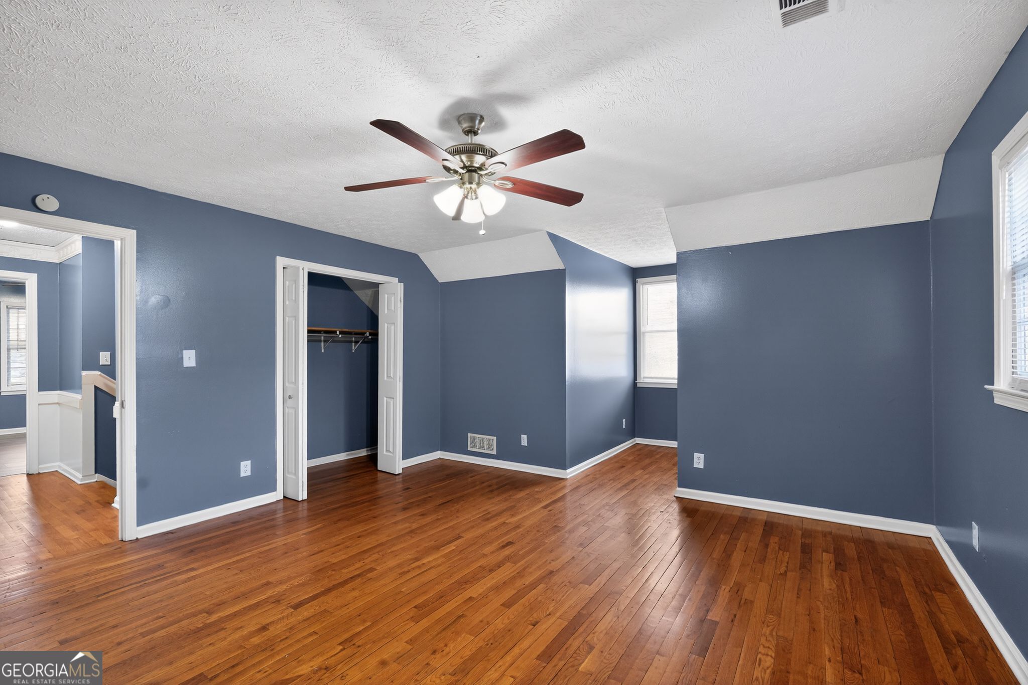 6581 Woodrow Road Lithonia, GA 30038 - Photo 21 of 34 a view of a room with wooden floor and a ceiling fan