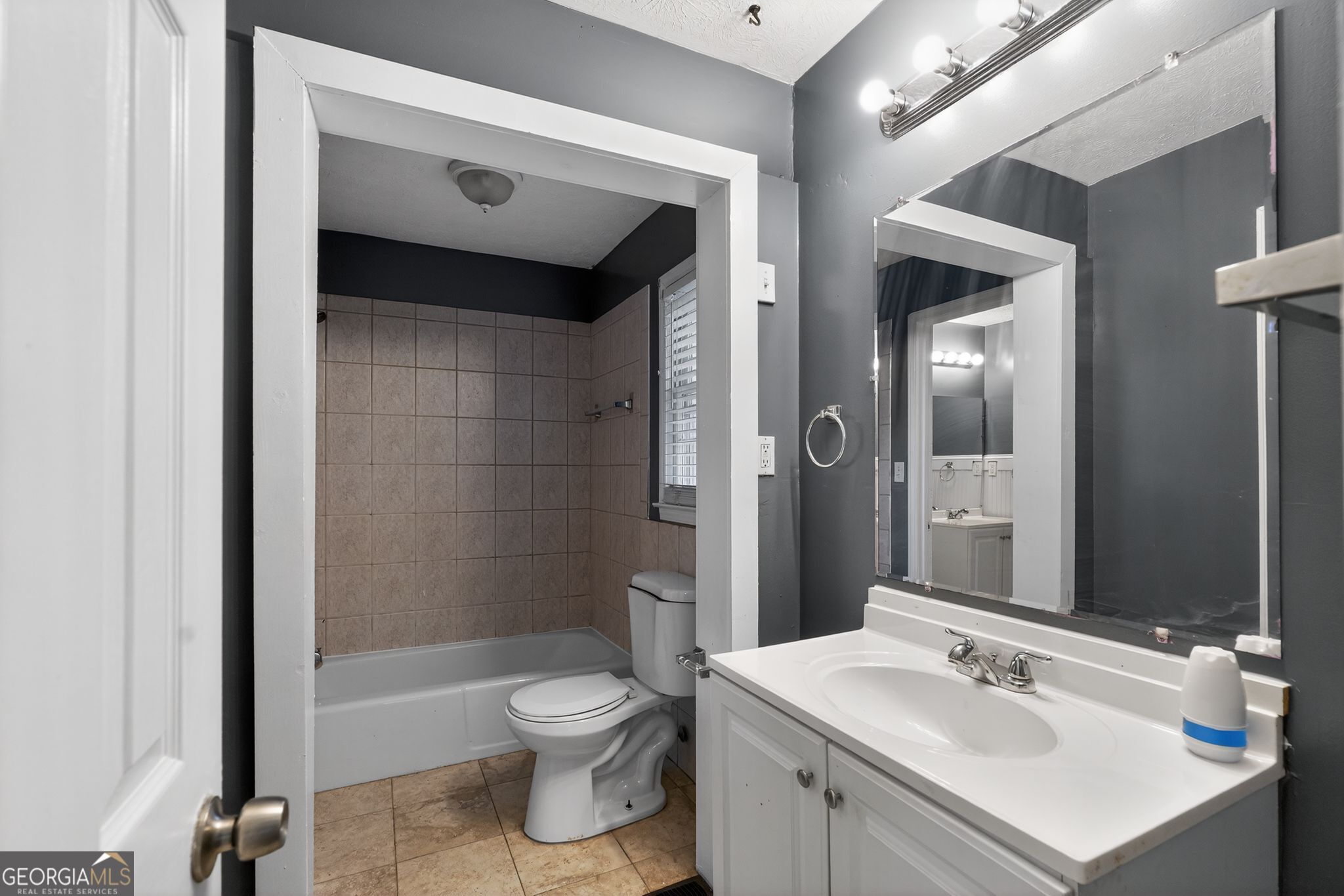 6581 Woodrow Road Lithonia, GA 30038 - Photo 24 of 34 a bathroom with a sink toilet and shower