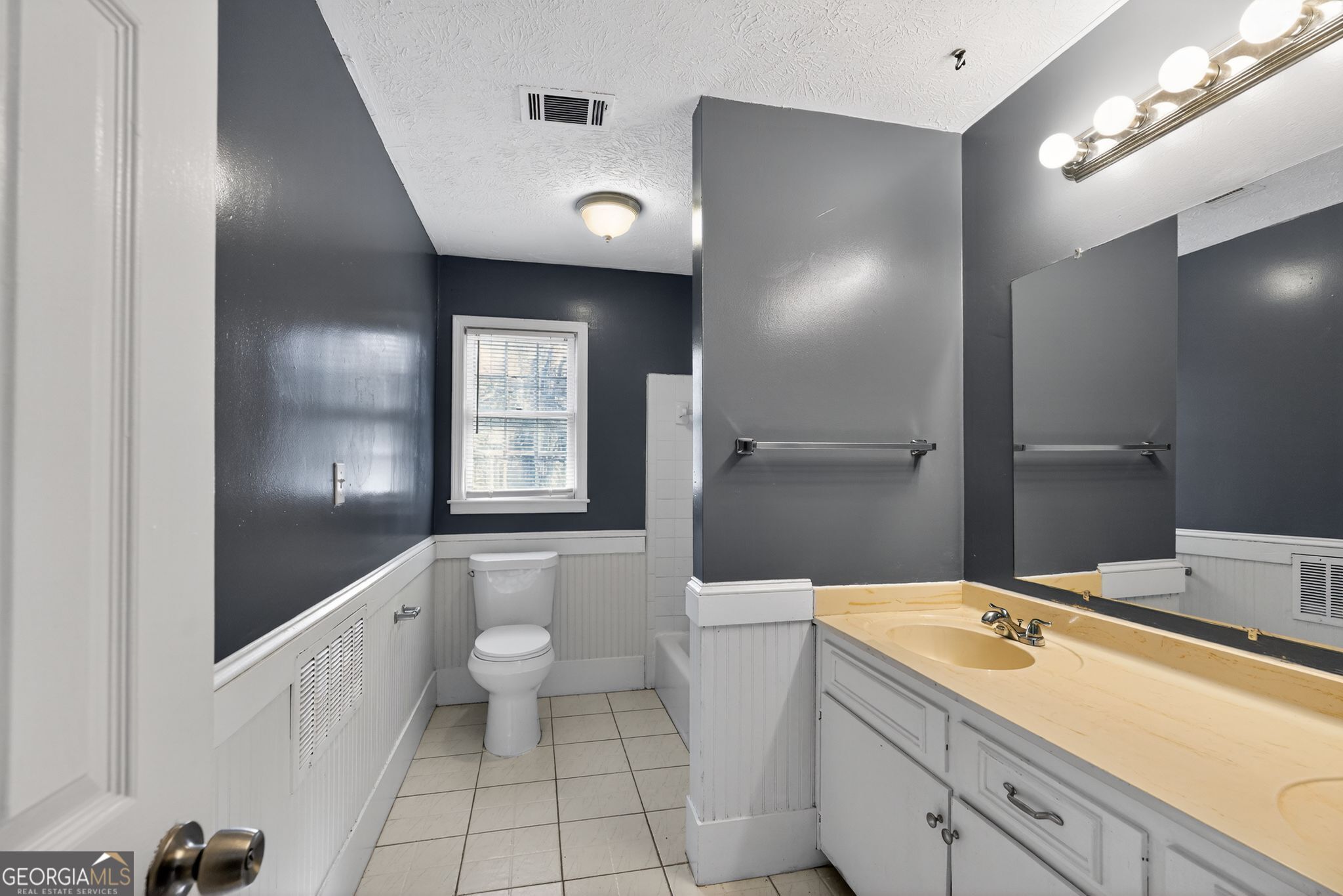 6581 Woodrow Road Lithonia, GA 30038 - Photo 25 of 34 a bathroom with a toilet sink and mirror