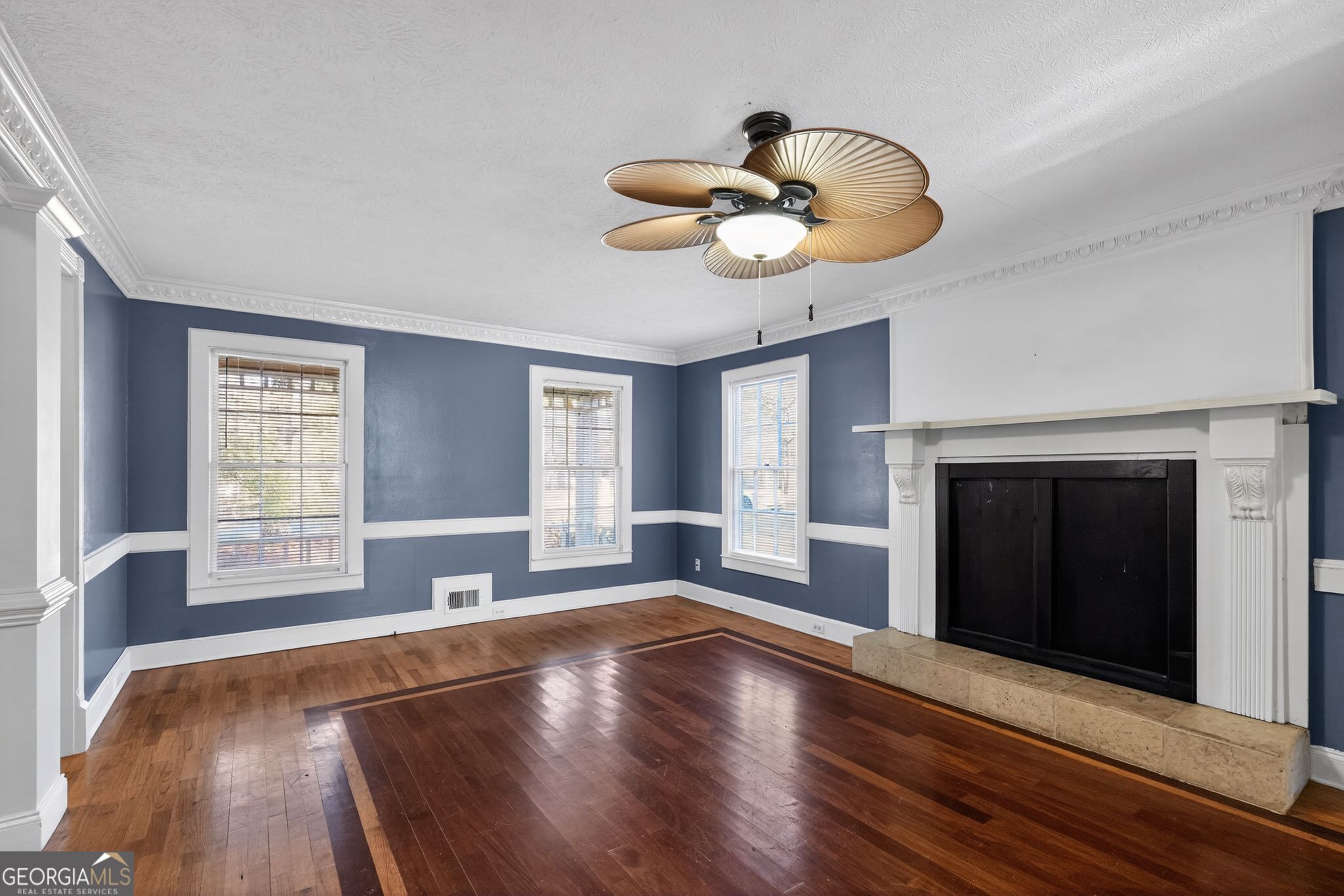 6581 Woodrow Road Lithonia, GA 30038 - Photo 5 of 34 a view of an empty room with wooden floor and a window