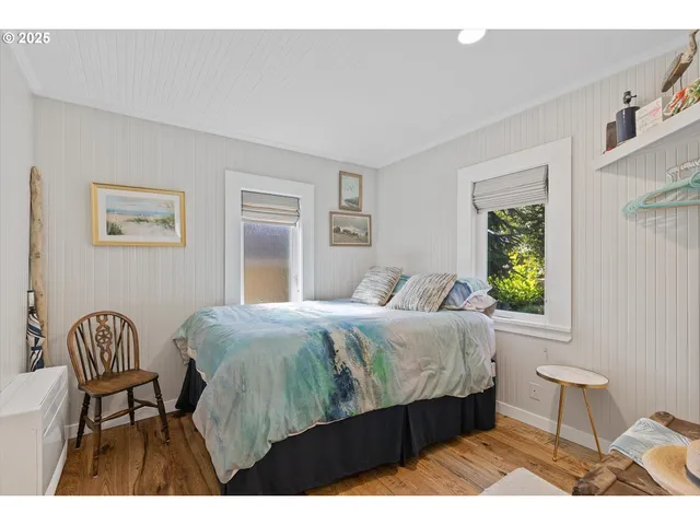 a bedroom with a bed chair and window