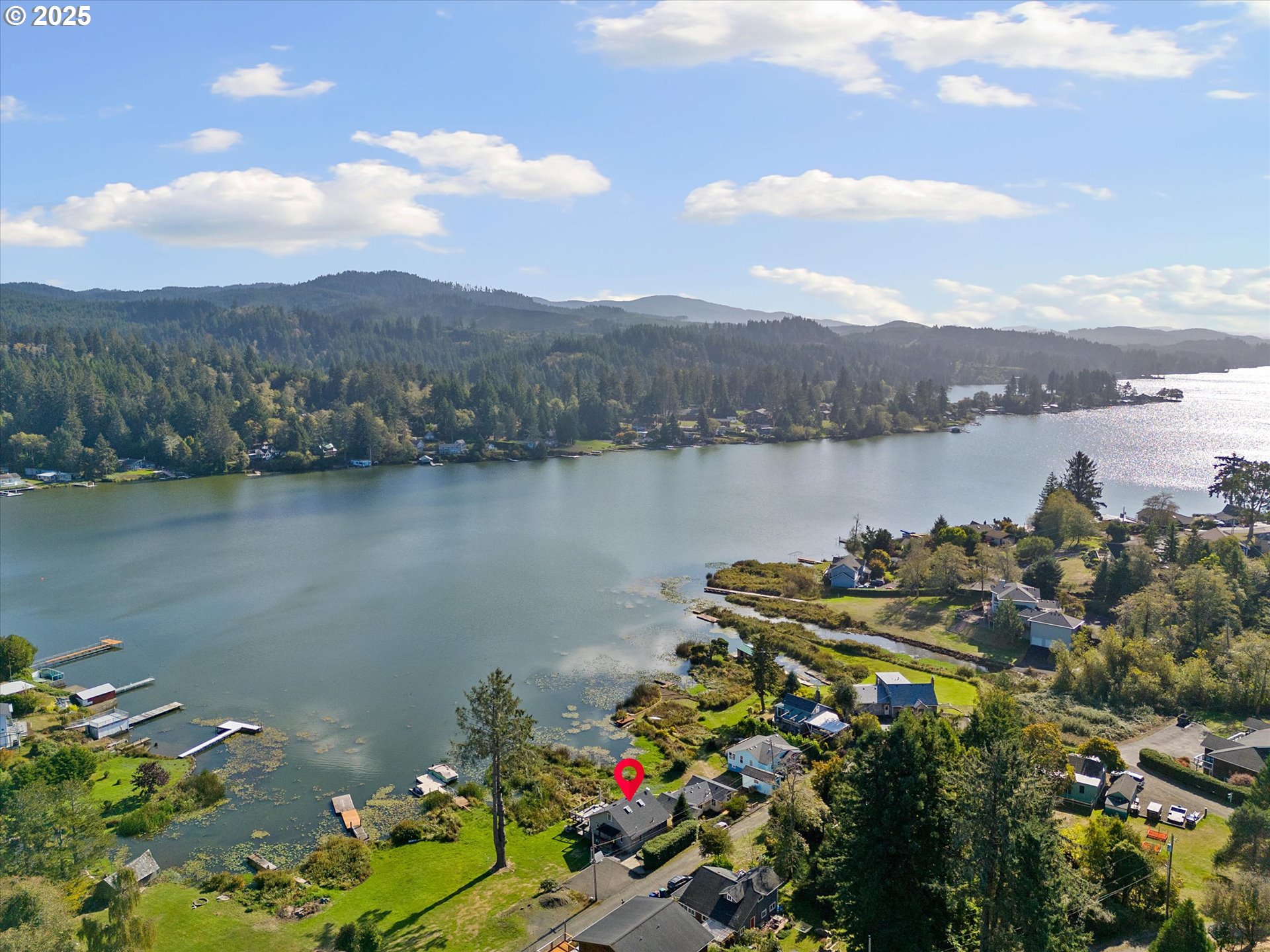 4692 Northeast I Avenue Neotsu, OR 97364 - Photo 2 of 41 a view of a lake with a mountain