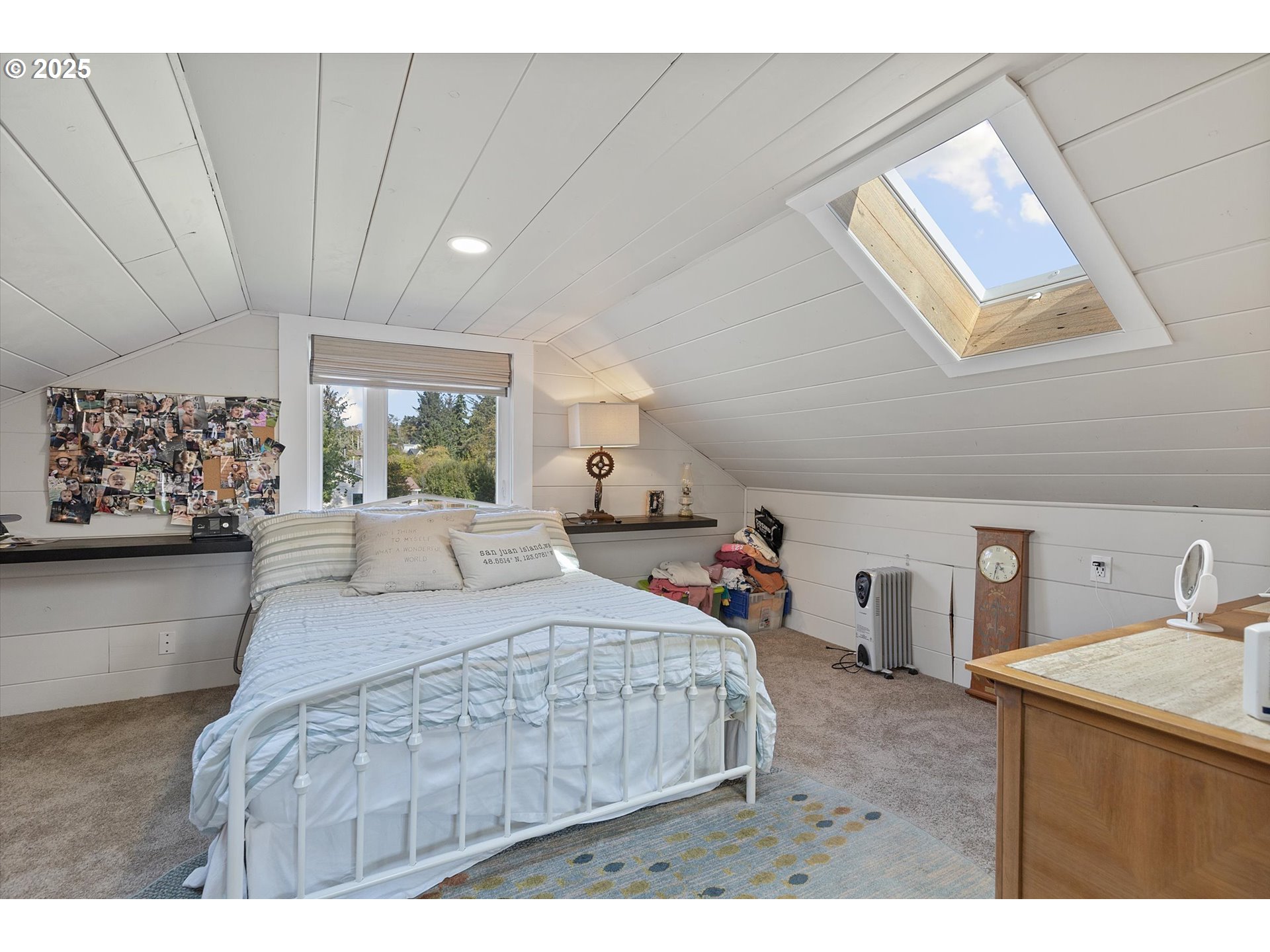 4692 Northeast I Avenue Neotsu, OR 97364 - Photo 21 of 41 a bedroom with a large bed and a chandelier