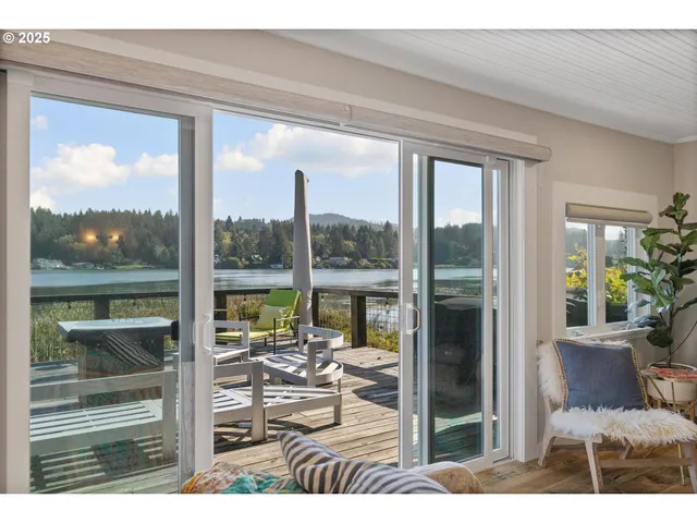 a living room with hardwood floor and a floor to ceiling window