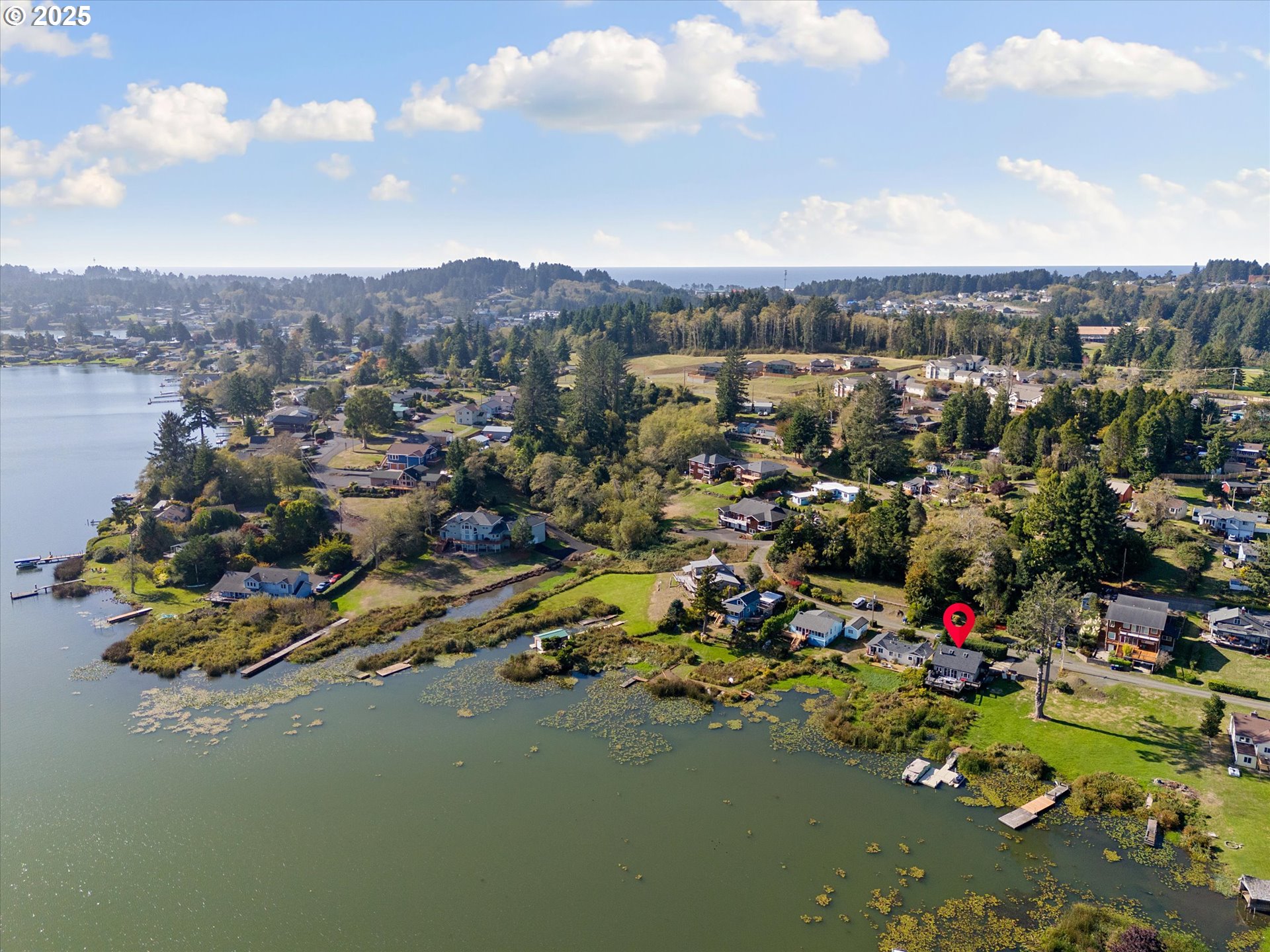 4692 Northeast I Avenue Neotsu, OR 97364 - Photo 36 of 41 an aerial view of residential houses with outdoor space and lakeside