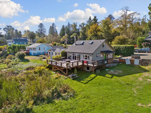 an aerial view of a house with swimming pool and a yard