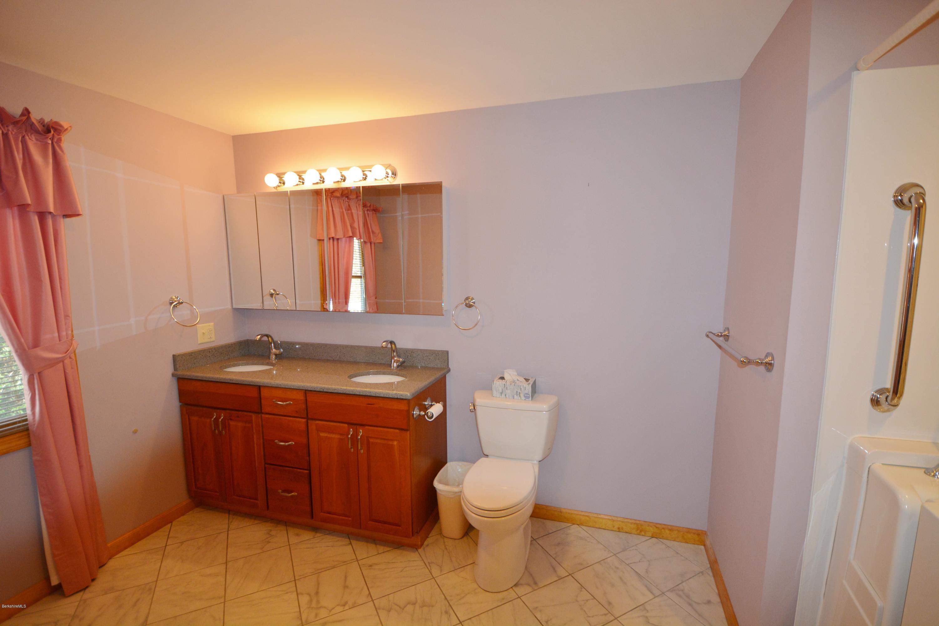 240 West Center Road Otis, MA 01253 - Photo 8 of 14 a bathroom with a toilet a sink and mirror