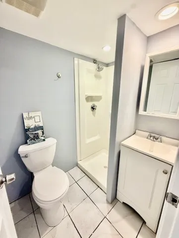 a bathroom with a toilet sink and a mirror