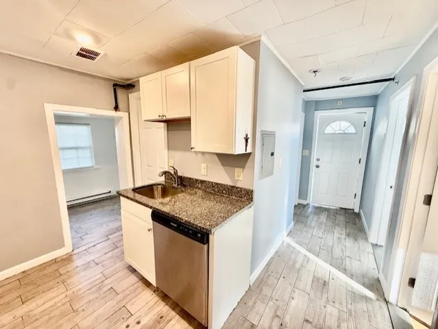 a kitchen with granite countertop a sink stove and refrigerator