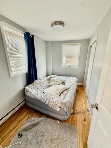 a bedroom with a bed and a window