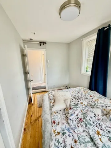 a bedroom with a bed and a mirror