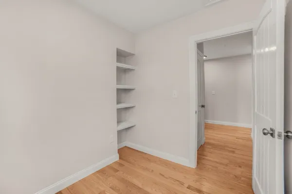 a view of a room with wooden floor