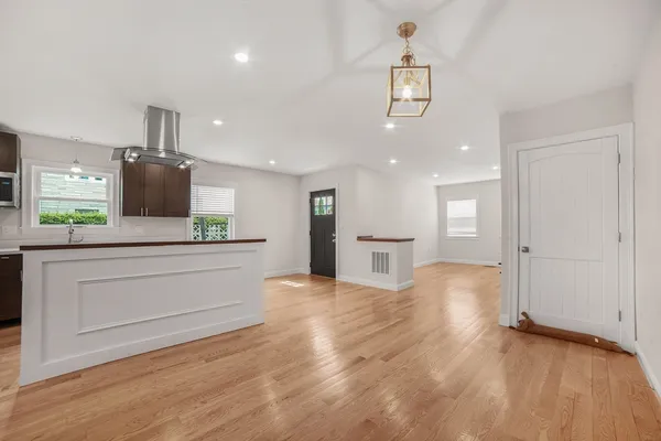 a view of kitchen with granite countertop cabinets and refrigerator