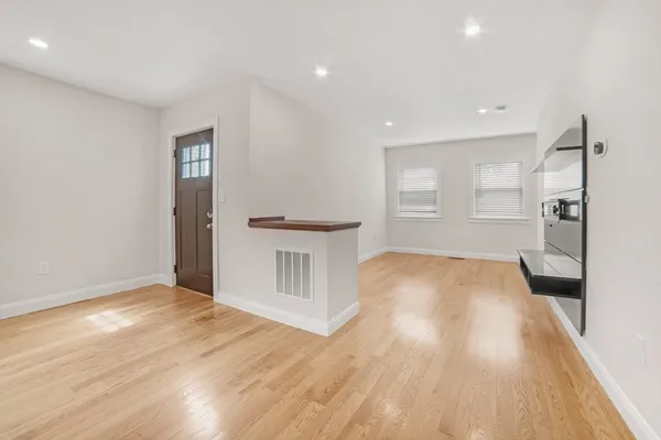 a view of a kitchen with wooden floor and a sink