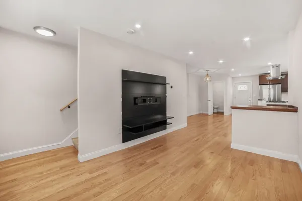 a view of kitchen with microwave and refrigerator