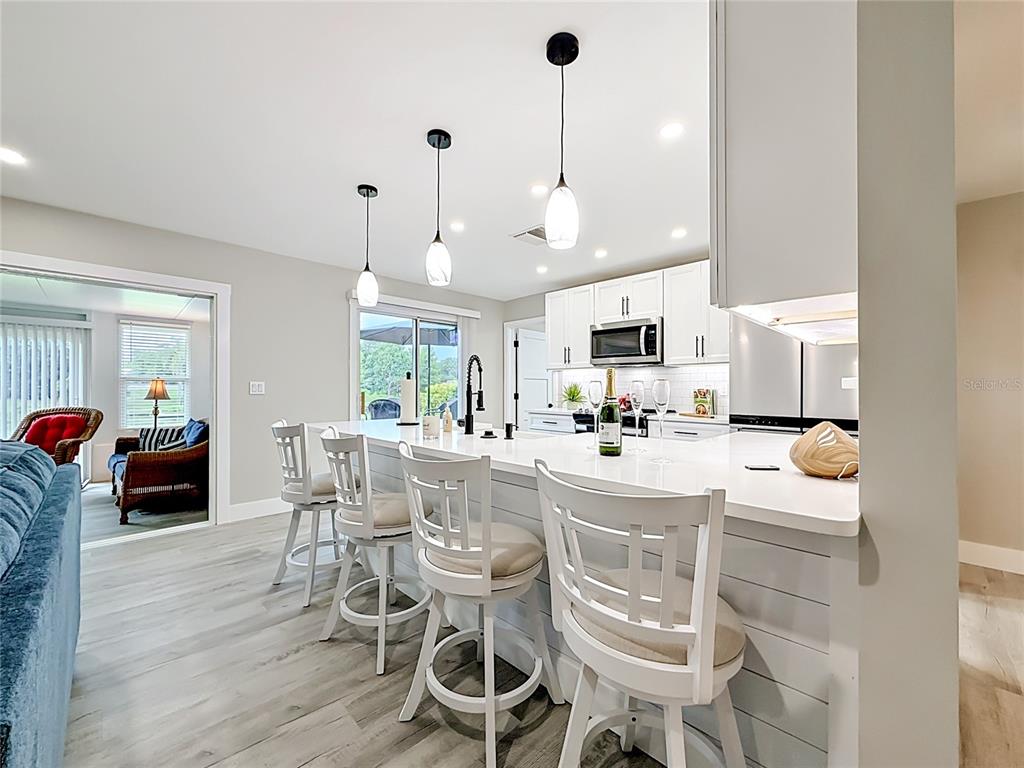 508 Shore Drive Largo, FL 33771 - Photo 7 of 31 a large kitchen with a table and chairs