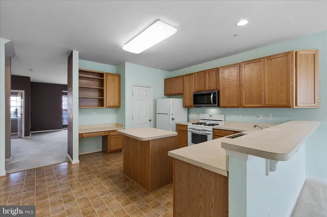 a kitchen that has a sink and a stove in it