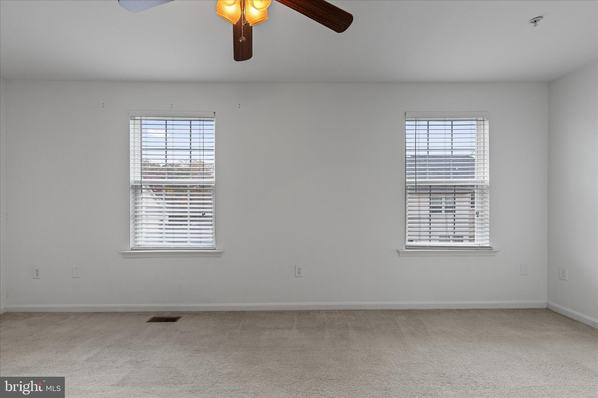 22742 Bayside Way California, MD 20619 - Photo 22 of 33 an empty room with chandelier fan and windows