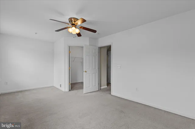 a view of room with a ceiling fan and window