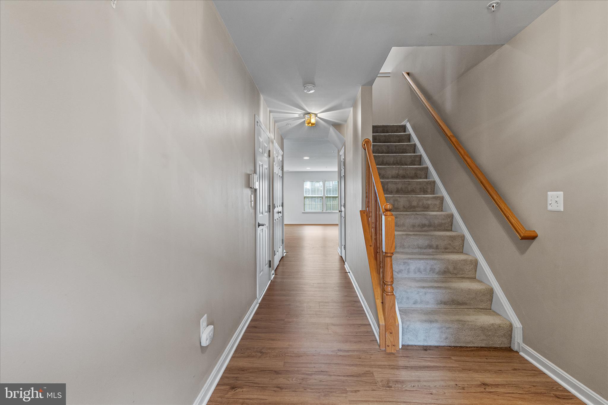22742 Bayside Way California, MD 20619 - Photo 3 of 33 a view of a hallway with wooden floor and staircase
