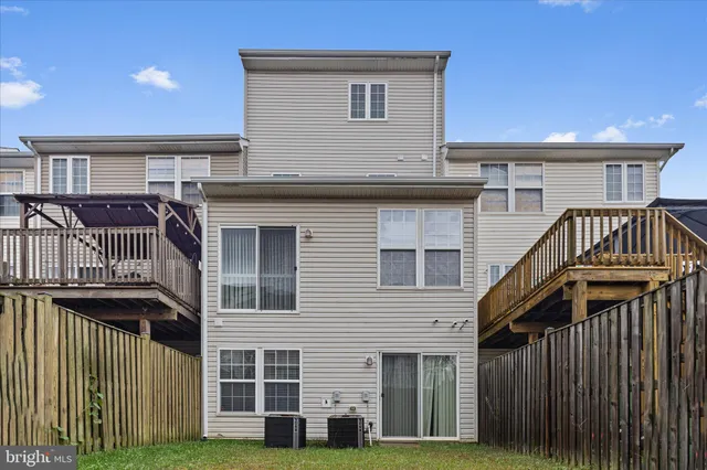 a view of a house with wooden deck