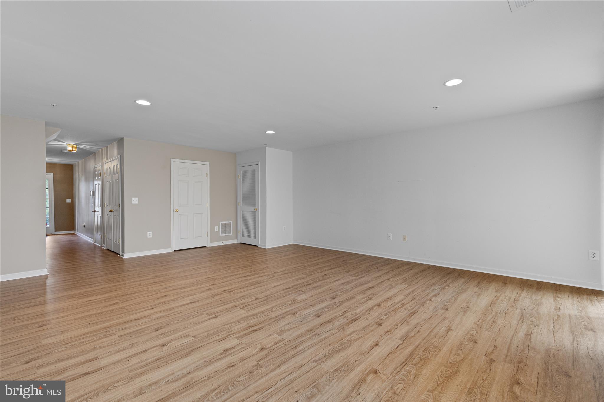 22742 Bayside Way California, MD 20619 - Photo 8 of 33 a view of an empty room with wooden floor and a window