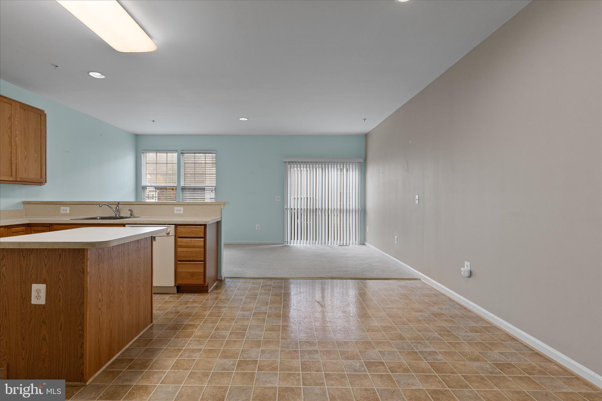 22742 Bayside Way California, MD 20619 - Photo 9 of 33 a large kitchen with granite countertop a sink a counter top space and cabinets
