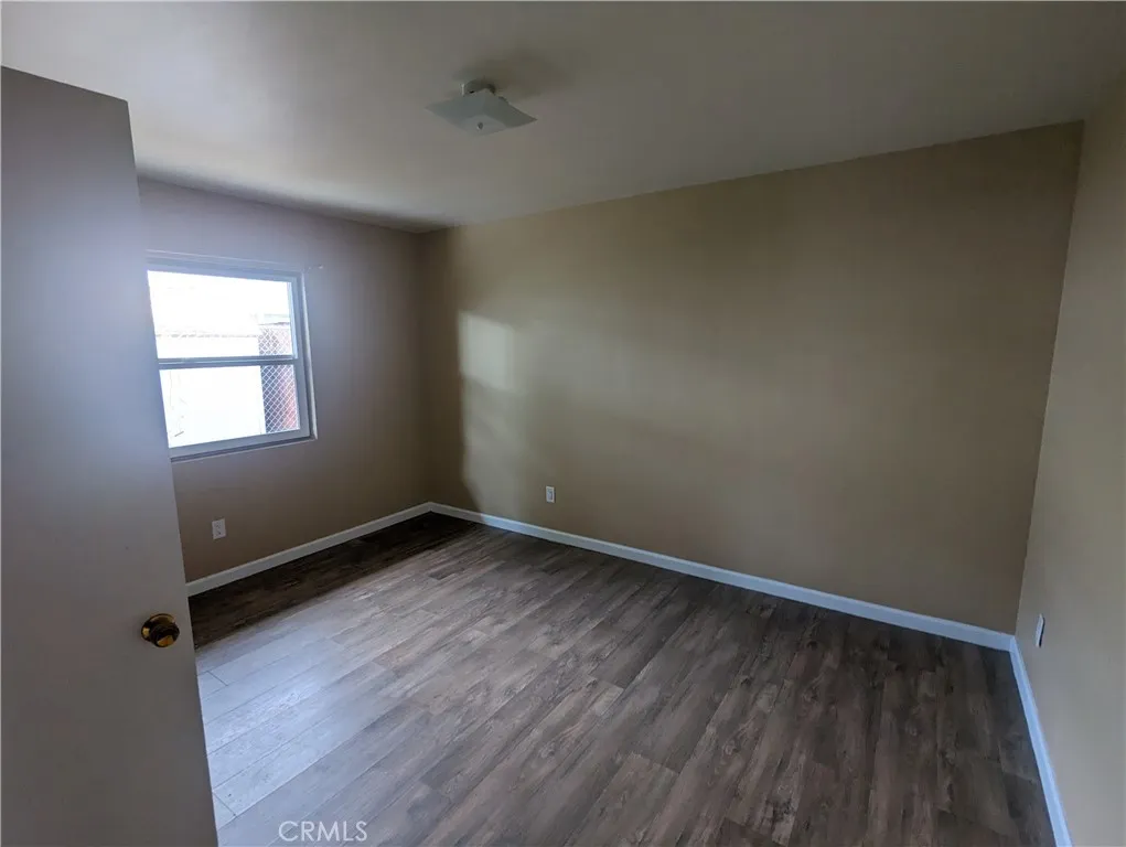 9330 Saffron Court Riverside, CA 92503 - Photo 16 of 21 an empty room with wooden floor and windows