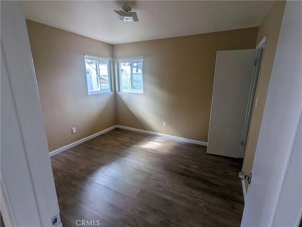 9330 Saffron Court Riverside, CA 92503 - Photo 20 of 21 an empty room with wooden floor and windows