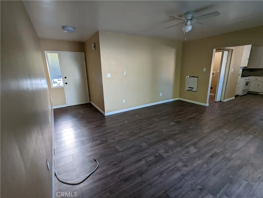 9330 Saffron Court Riverside, CA 92503 - Photo 2 of 21 an empty room with wooden floor and a window