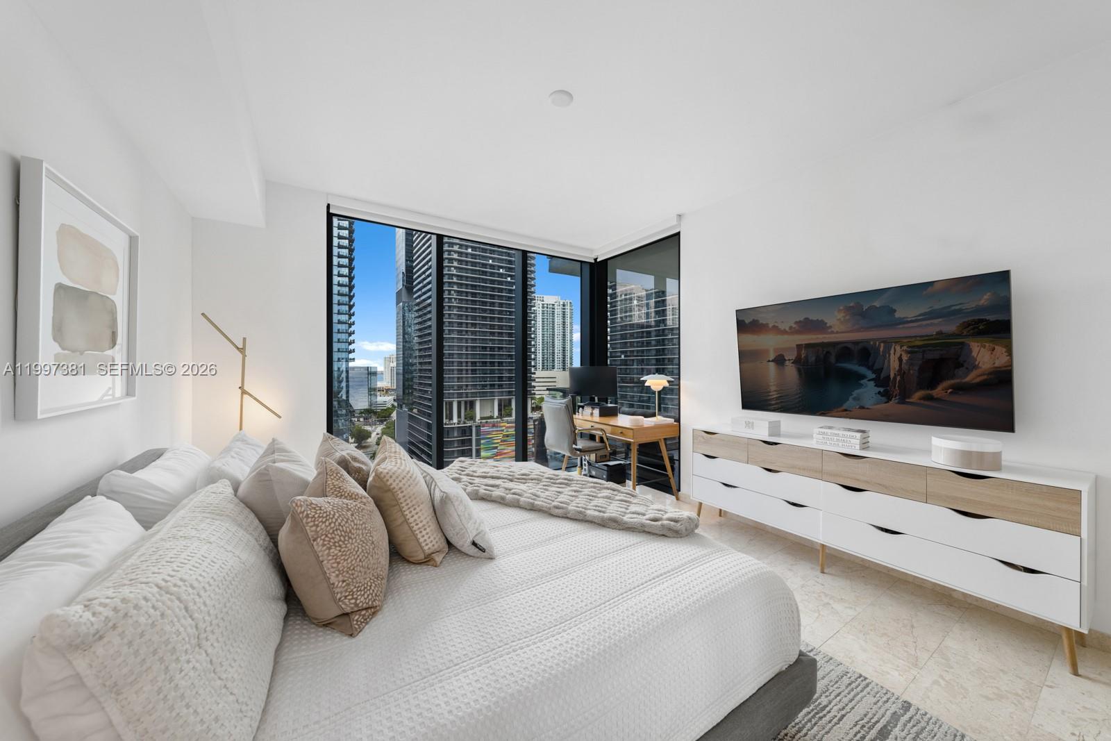 88 Southwest 7th Street, Unit 1401 Miami, FL 33130 - Photo 12 of 27 a bedroom with a bed and a flat screen tv