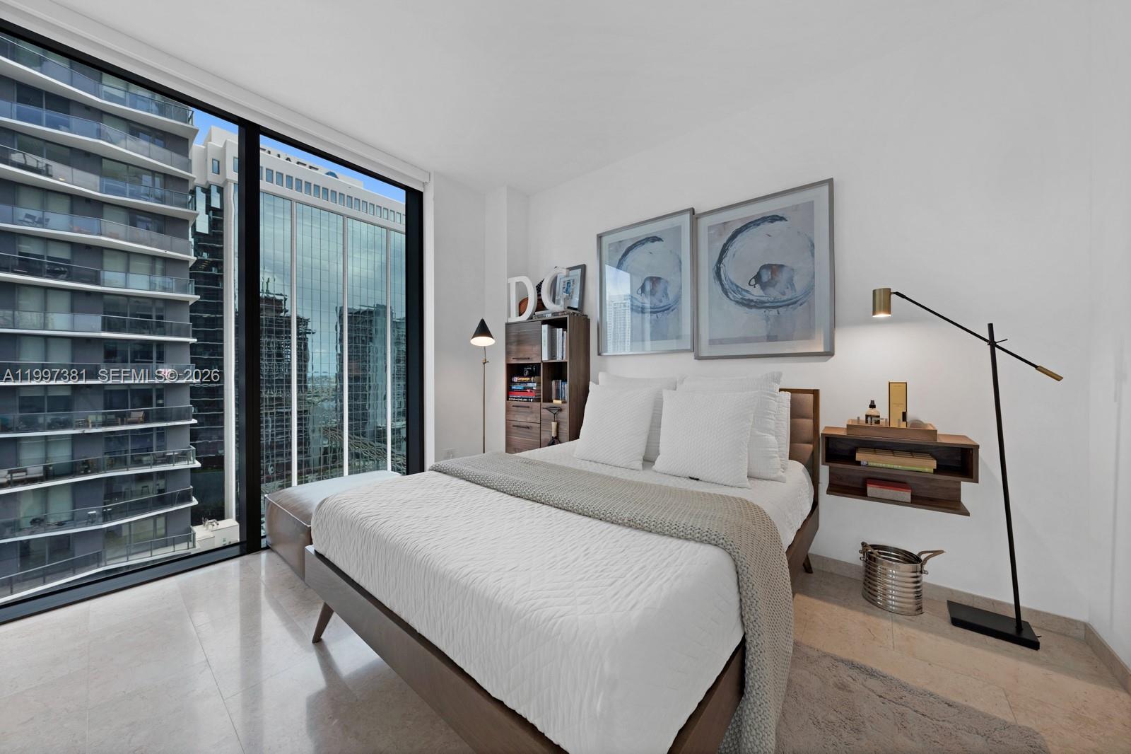 88 Southwest 7th Street, Unit 1401 Miami, FL 33130 - Photo 17 of 27 a bedroom with a bed and a cabinets