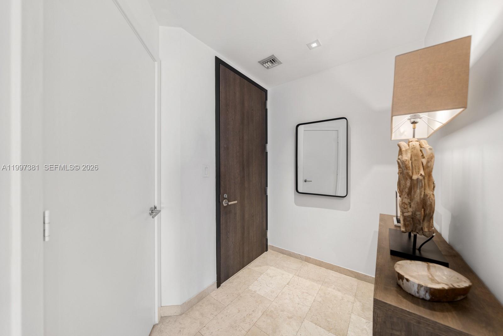 88 Southwest 7th Street, Unit 1401 Miami, FL 33130 - Photo 21 of 27 a bedroom with a bed and a couch
