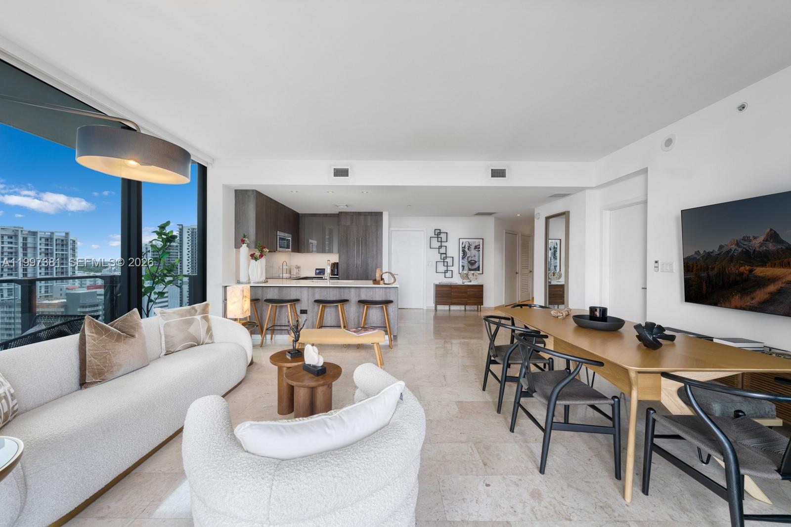 88 Southwest 7th Street, Unit 1401 Miami, FL 33130 - Photo 5 of 27 a living room with furniture and a flat screen tv
