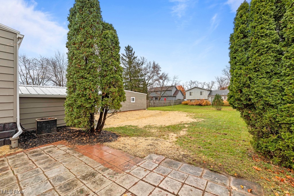 16216 Corkhill Road Maple Heights, OH 44137 - Photo 33 of 35 View of yard featuring a patio area and central air condition unit