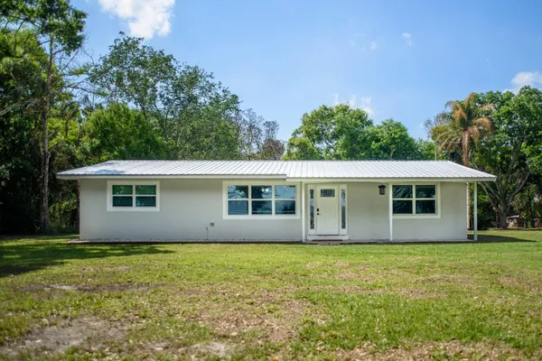 a view of house with yard